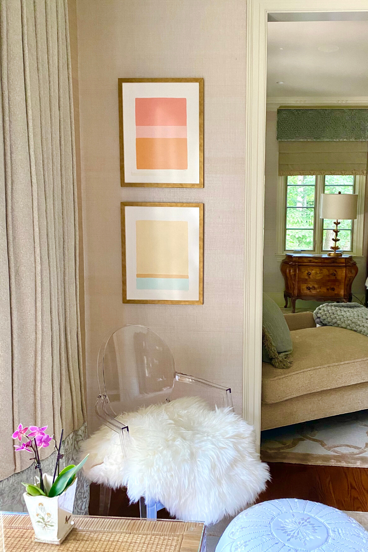 Two custom framed paintings by artist Laurie Fisher are displayed in an elegant home office, adding a pop of color in a previously blank corner.