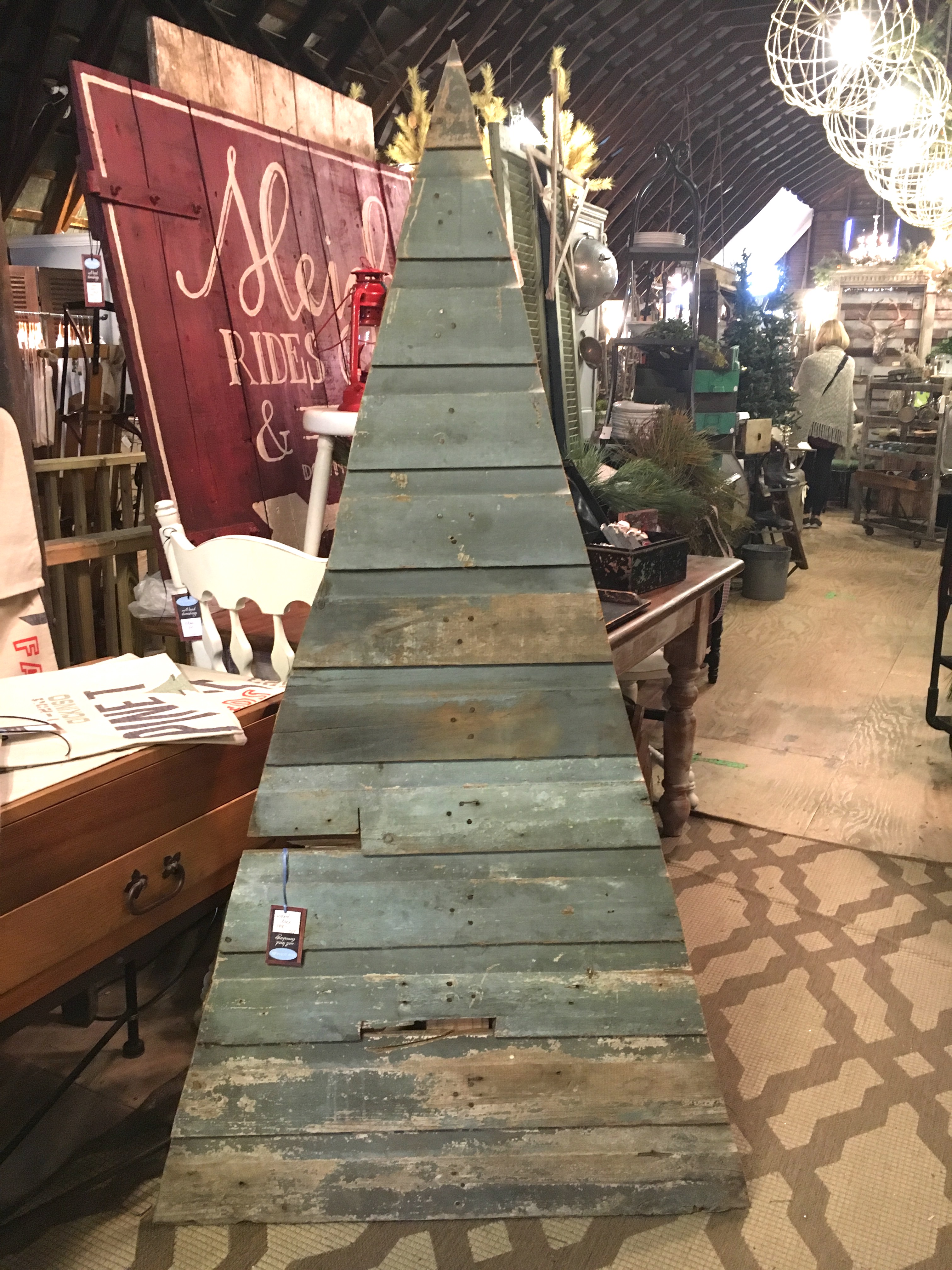 rustic christmas tree display of salvaged wood boards painted green